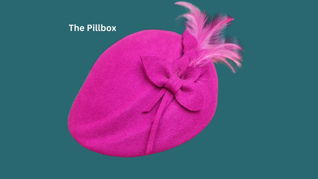 A cerise pink pillbox hat with feathers