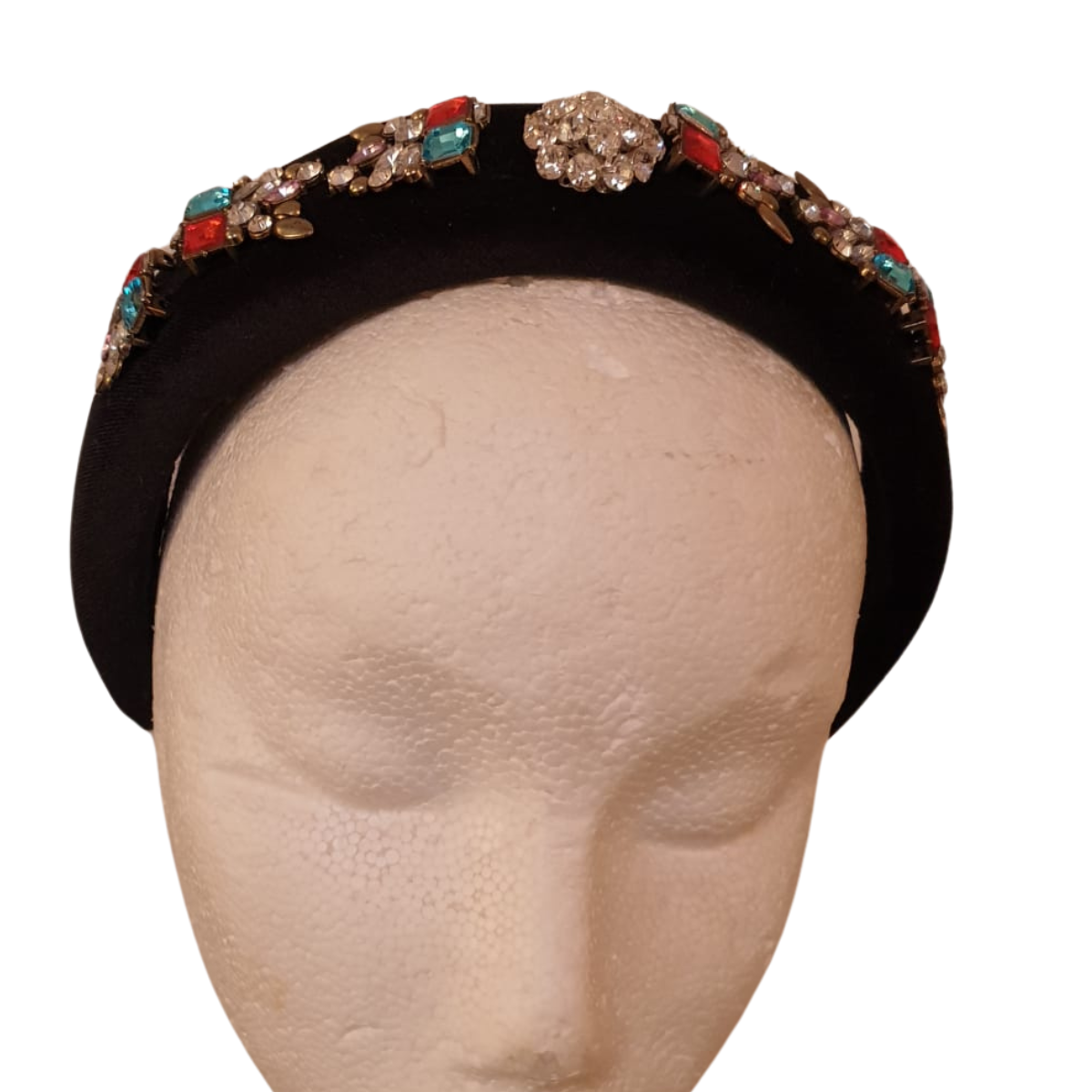 Dress up any outfit with our luxurious Black Beaded Velvet Headband! Hand-decorated with dazzling diamanté and striking turquoise and red clusters, this headband will make you feel glamorous and confident. Perfect for special occasions or adding a touch of elegance to your everyday look.