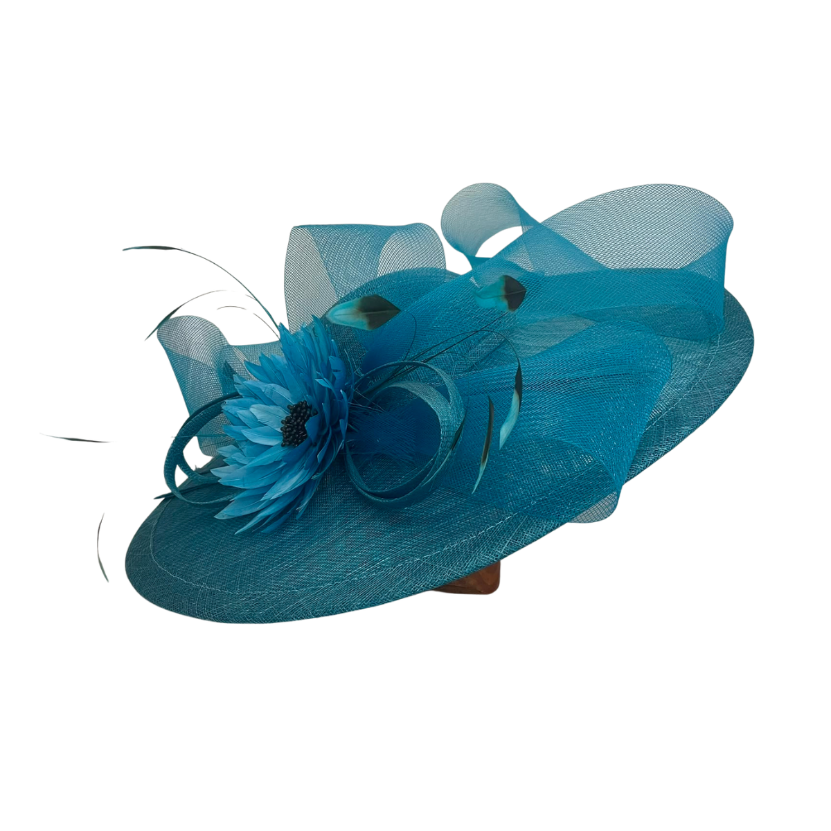 A teal blue fascinator hat featuring a wide brim, layered mesh ribbon, a decorative fascinator flower, and wispy feather accents, shown on a plain white background.