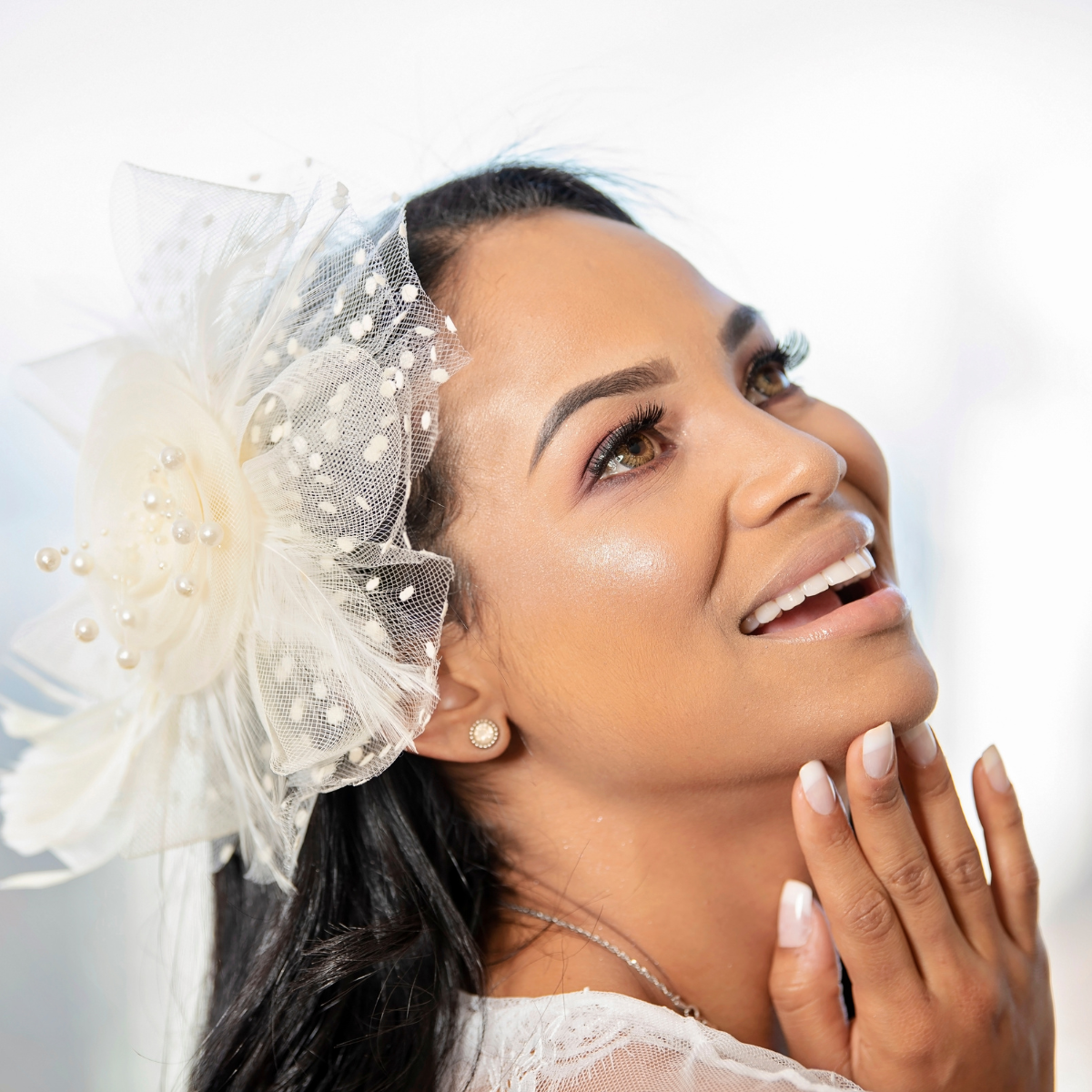 Lady wearing a cream net fascinator for a wedding