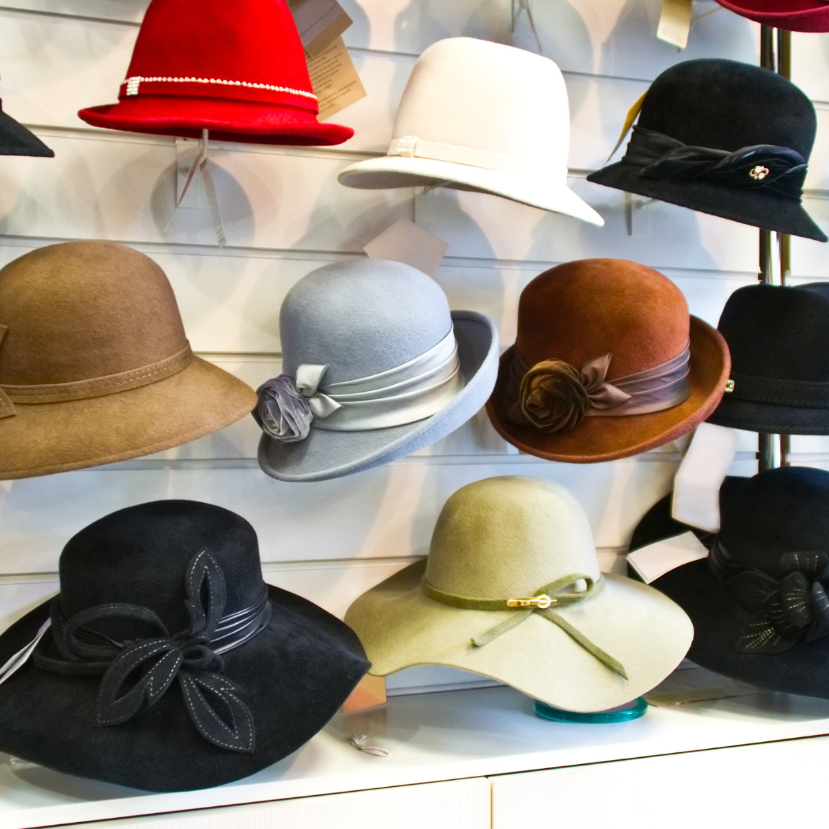 Different types of felt hats on a wall display