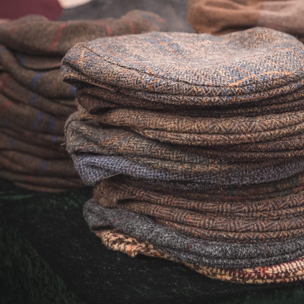 A pile of tweed flat caps