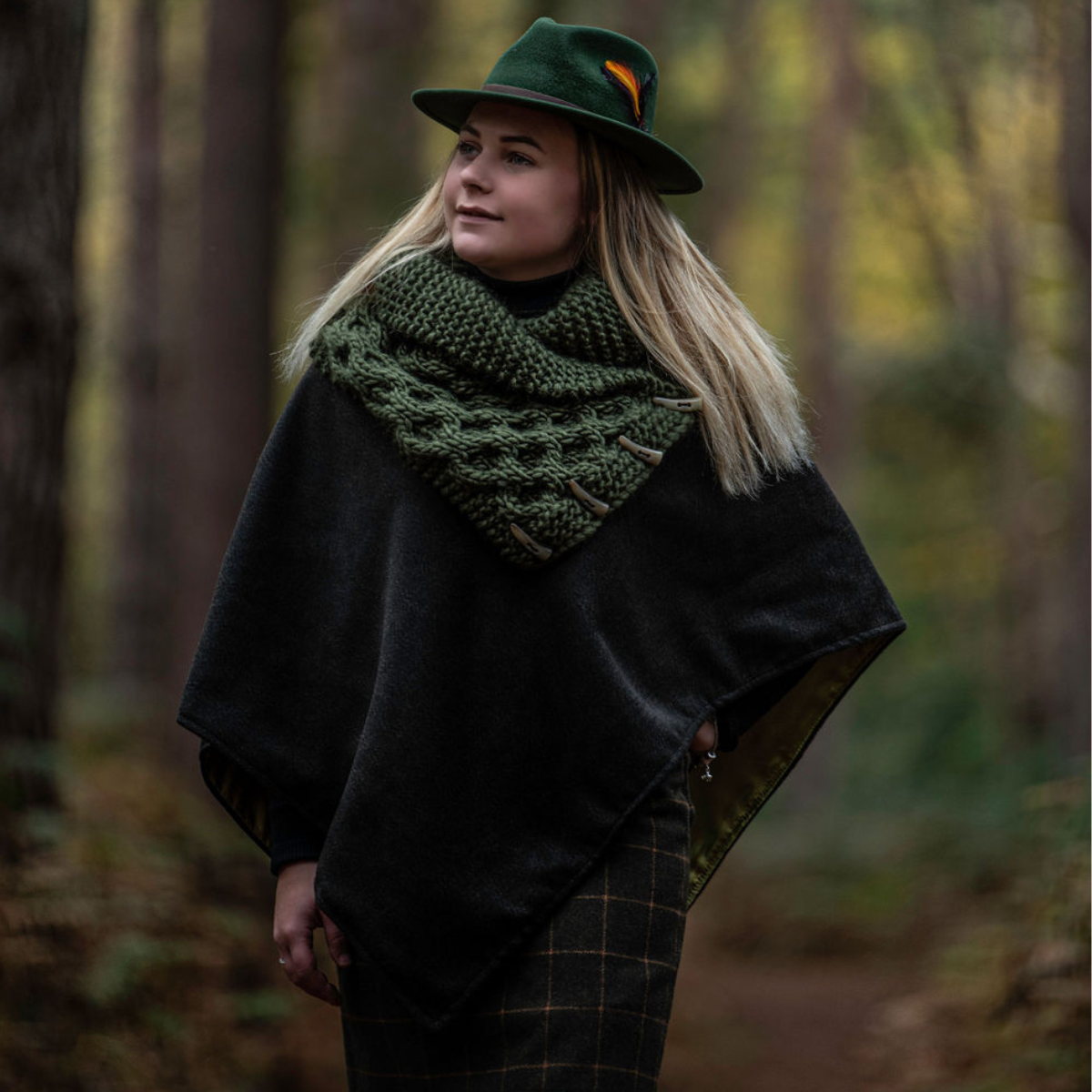 Lady in the woods wearing a knitted shawl