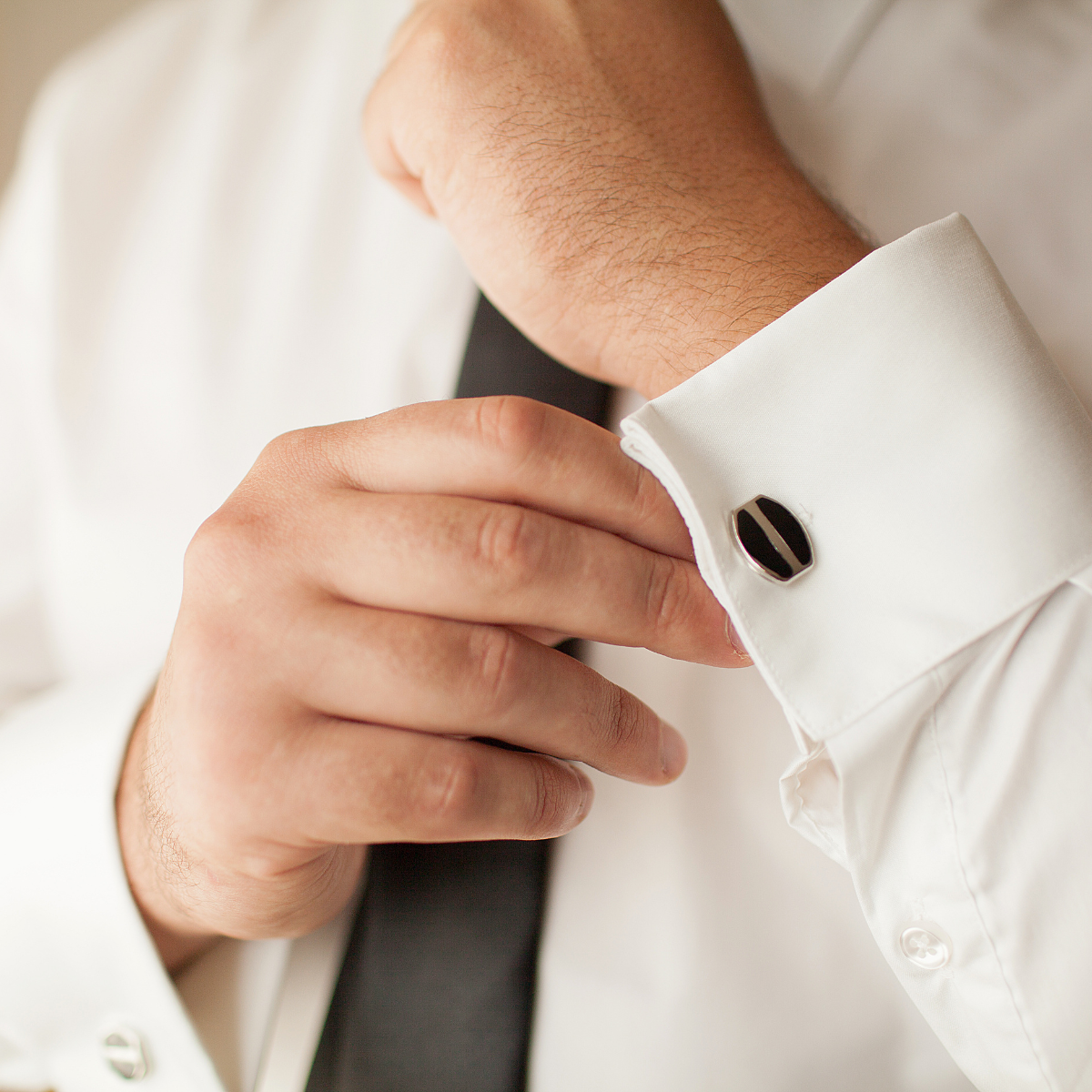 Man adjusting his cufflinks