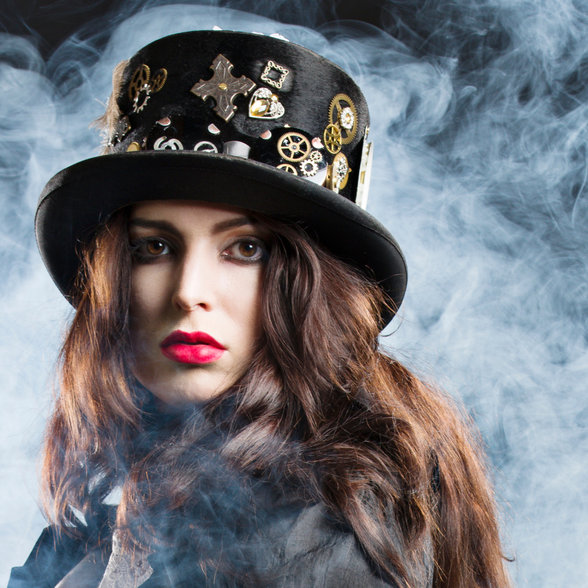 Lady Steampunker wearing a top hat covered with badges, cogs and buttons.