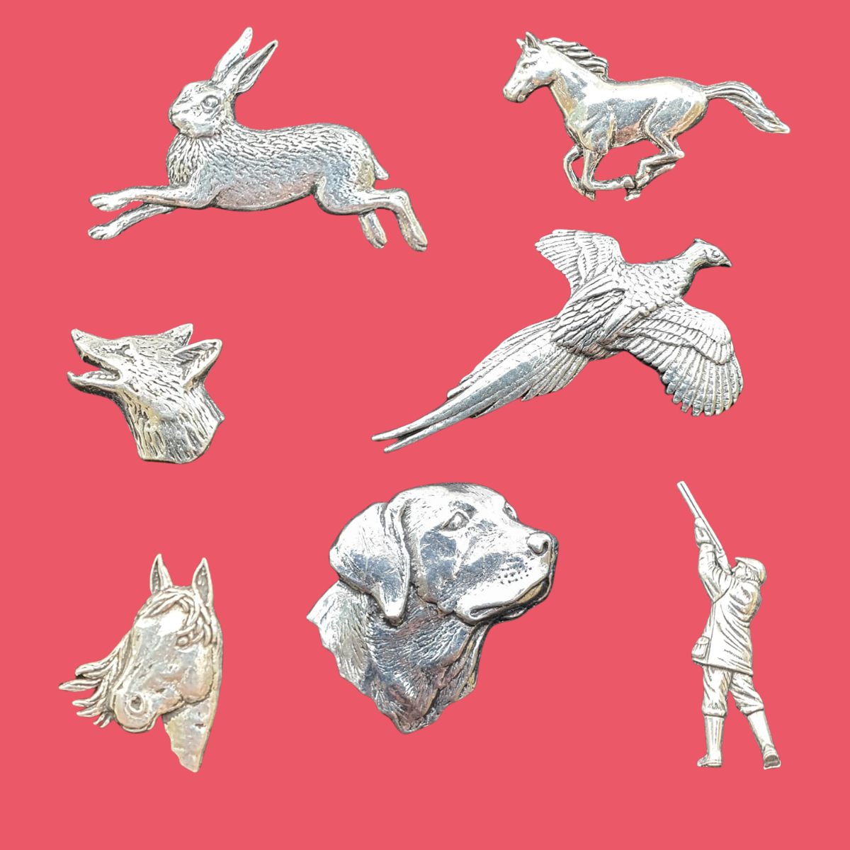 Various animal shaped tie pins on a pink background
