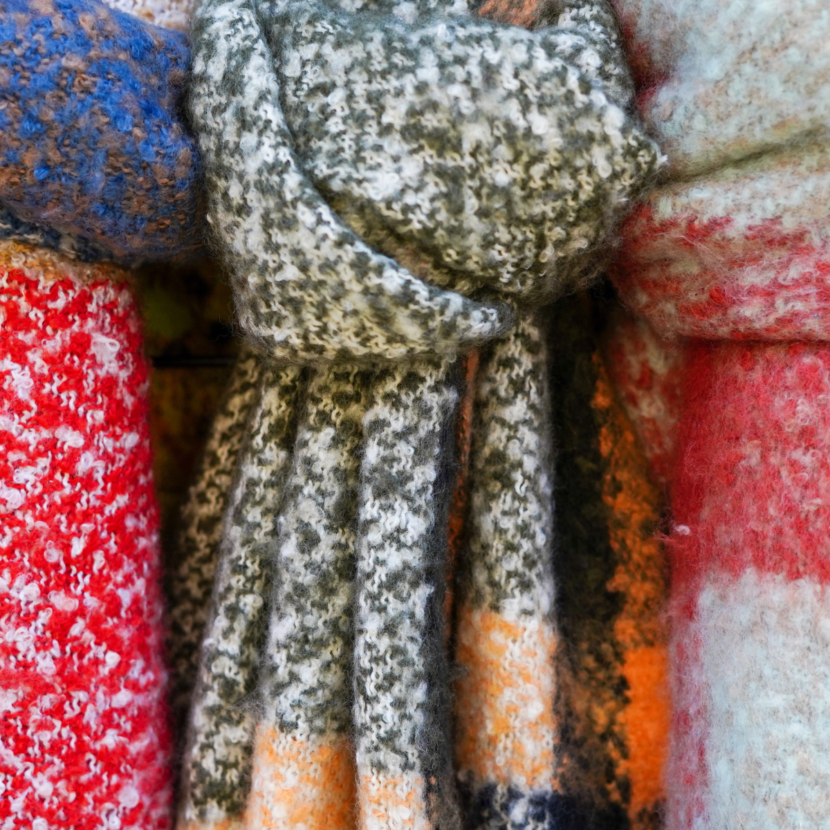 A row of three winter scarves