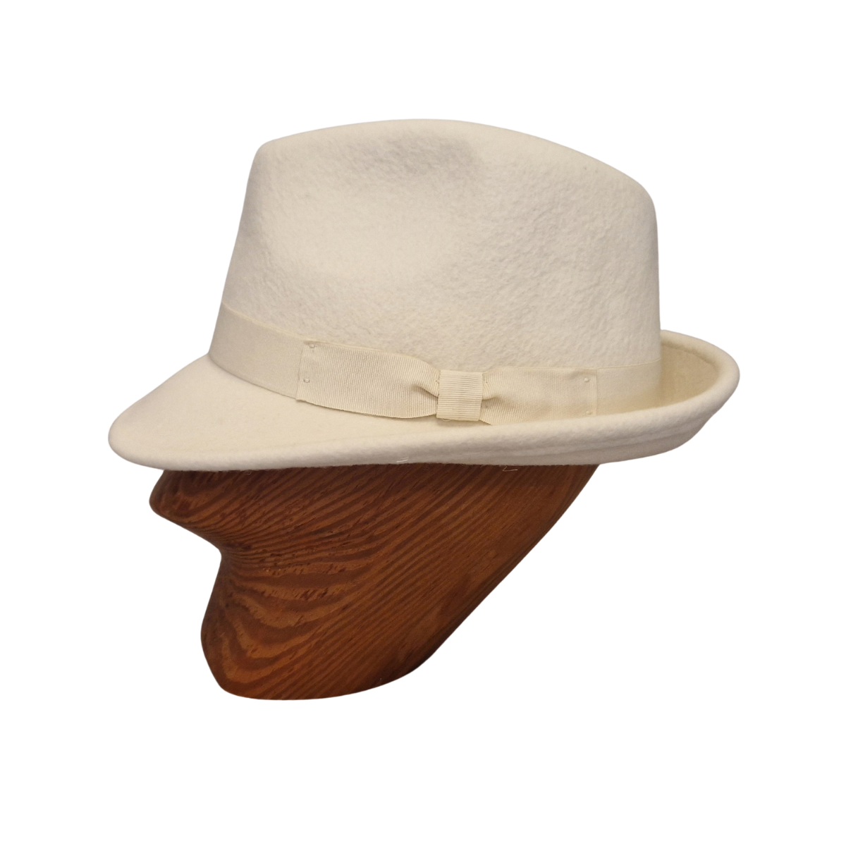 A cream felt trilby hat with a matching band and bow, displayed on a brown wooden mannequin head against a white background. Side