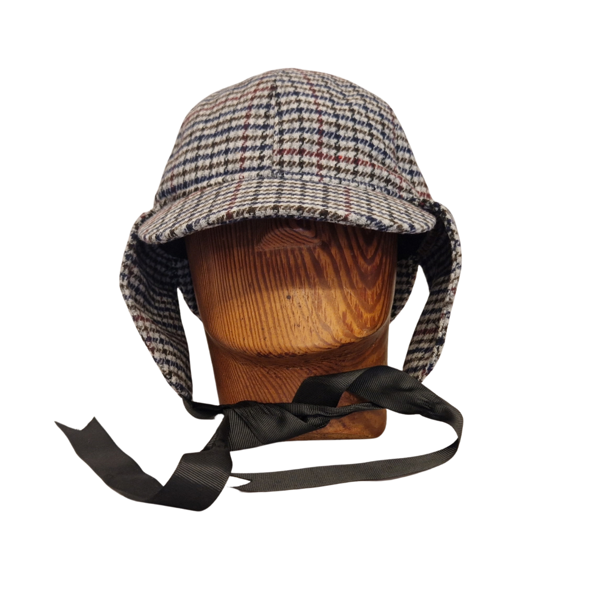 A classic deerstalker hat with a grey,  brown, black, and white houndstooth pattern, displayed on a wooden mannequin head against a plain white background. Flaps down