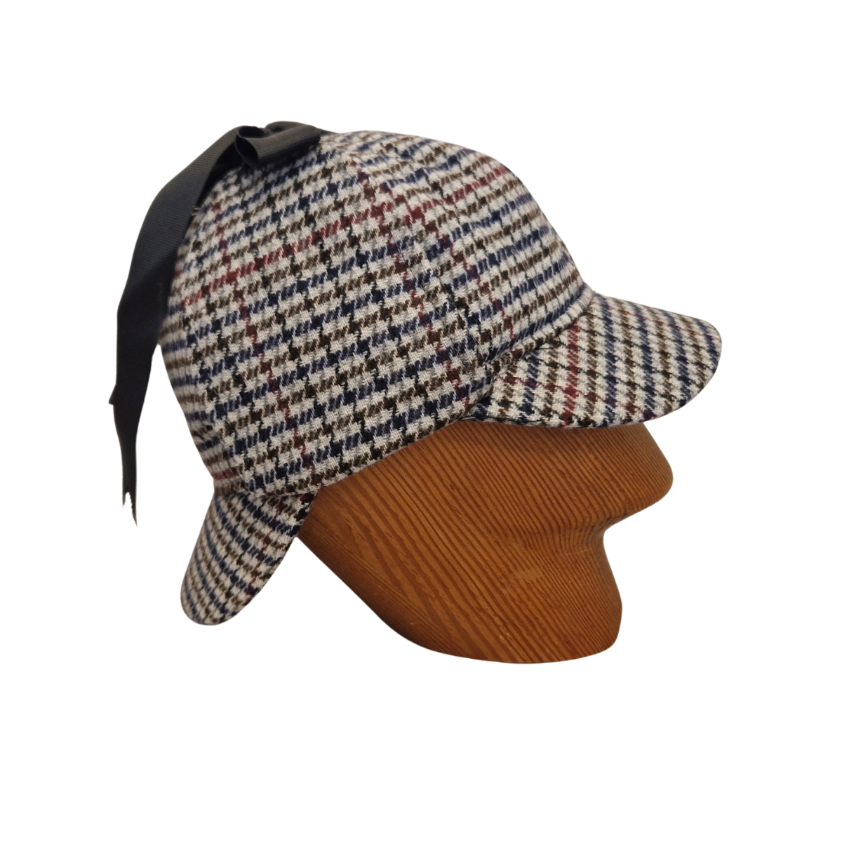 A classic deerstalker hat with a grey,  brown, black, and white houndstooth pattern, displayed on a wooden mannequin head against a plain white background. Side