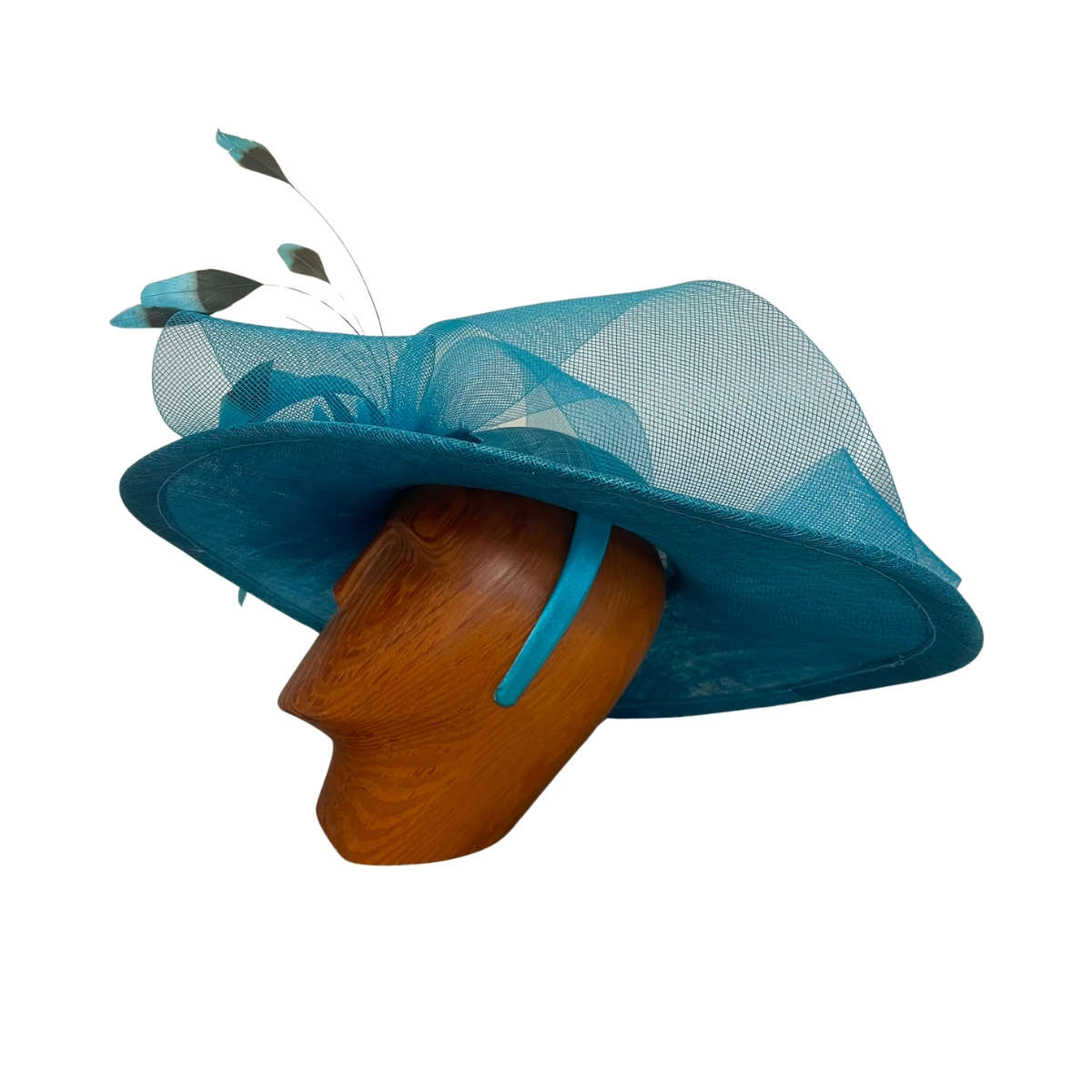 A turquoise blue fascinator hat with a wide brim, sheer mesh crown, and decorative feather accents, displayed on a brown wooden mannequin head against a white background.